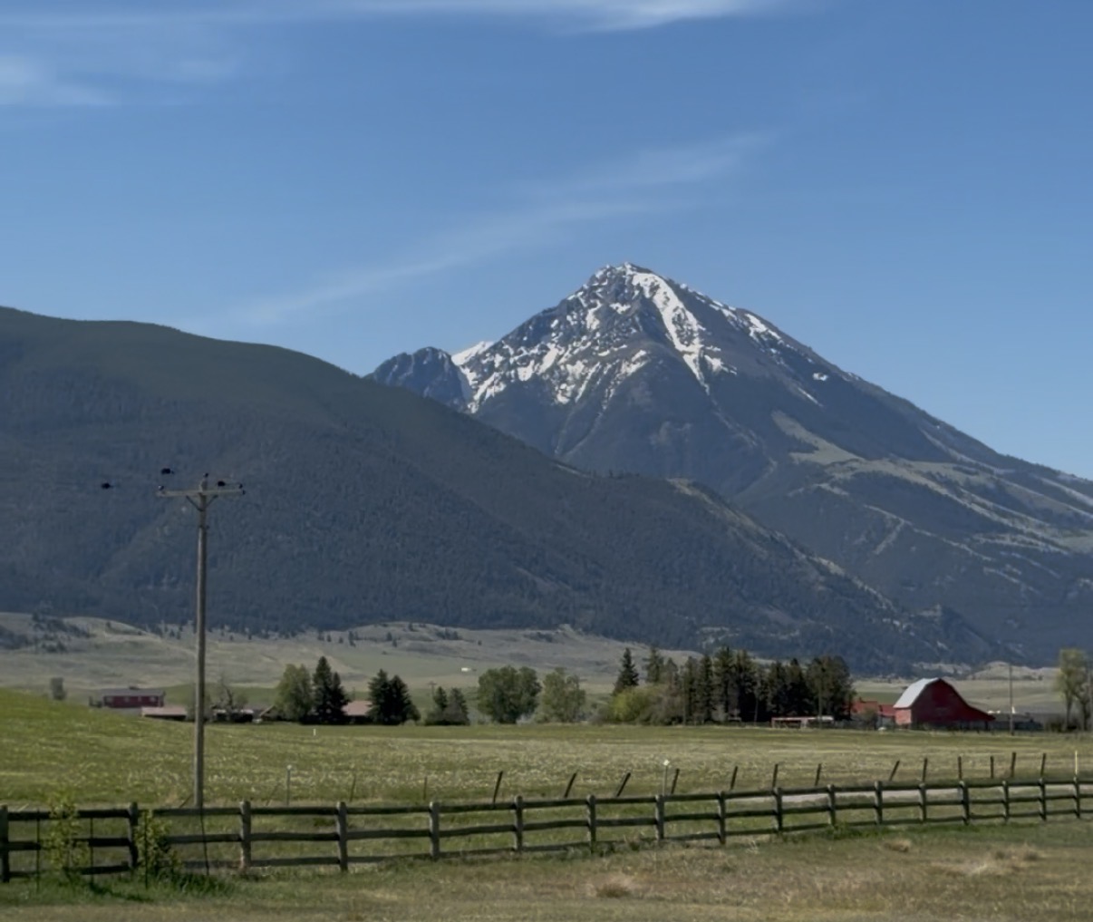 Mountain view over Paradise Valley near Pray, Montana with red barn and ranchland